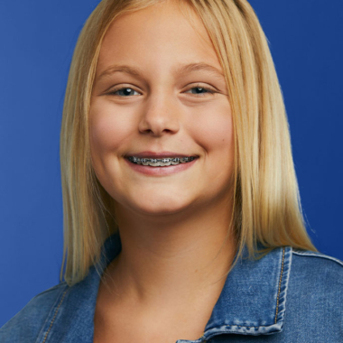 Image of young girl smiling with metal braces | Busby and Webb Orthodontics - Salisbury, Statesville, and Ablemarle, NC