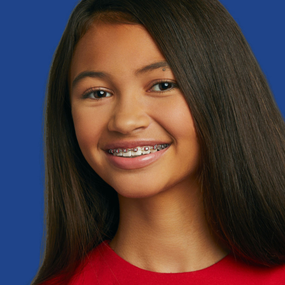 Image of young woman smiling with metal braces - Busby & Webb Orthodontics | Salisbury, NC