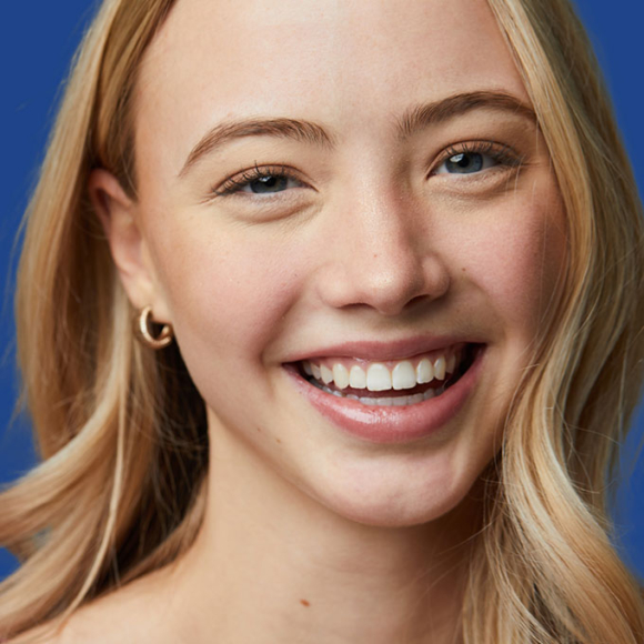 Image of smiling young woman after Invisalign treatment - Busby & Webb Orthodontics | Salisbury, NC